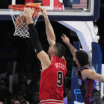 
              Chicago Bulls center Nikola Vucevic (9) dunks in front of Oklahoma City Thunder forward Kenrich Williams, right, in the first half of an NBA basketball game Friday, Nov. 25, 2022, in Oklahoma City. (AP Photo/Sue Ogrocki)
            