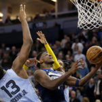 
              Timberwolves guard Anthony Edwards (1) shoots on Memphis Grizzlies guard Ja Morant, right, and Memphis Grizzlies forward Jaren Jackson Jr. (13) in the fourth quarter of an NBA basketball game Wednesday, Nov. 30, 2022, in Minneapolis. (AP Photo/Andy Clayton-King)
            
