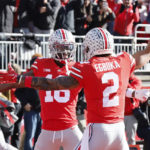 
              Ohio State receiver Marvin Harrison, left, celebrates his touchdown against Michigan with teammate Emeka Egbuka during the first half of an NCAA college football game on Saturday, Nov. 26, 2022, in Columbus, Ohio. (AP Photo/Jay LaPrete)
            