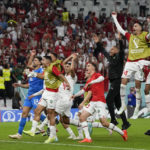 
              Morocco players celebrate after the World Cup group F soccer match between Belgium and Morocco, at the Al Thumama Stadium in Doha, Qatar, Sunday, Nov. 27, 2022. (AP Photo/Frank Augstein)
            