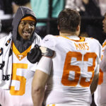
              Tennessee quarterback Hendon Hooker (5) talks with offensive linemen Cooper Mays (63) and Jerome Carvin (75) during the second half of the team's NCAA college football game against Vanderbilt, Saturday, Nov. 26, 2022, in Nashville, Tenn. (AP Photo/Wade Payne)
            