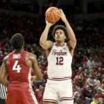 
              Fordham forward Elijah Gray (12) shoots over Arkansas guard Davonte Davis (4) during the first half of an NCAA college basketball game Friday, Nov. 11, 2022, in Fayetteville, Ark. (AP Photo/Michael Woods)
            
