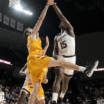 
              Texas A&M forward Henry Coleman III (15) shoots as Louisiana-Monroe forward Victor Bafutto (14) defends during the second half of an NCAA college basketball game Monday, Nov. 7, 2022, in College Station, Texas. (AP Photo/Sam Craft)
            