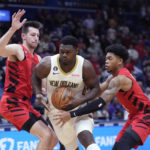 
              New Orleans Pelicans forward Zion Williamson (1) drives to the basket between Portland Trail Blazers forward Drew Eubanks, left, and guard Anfernee Simons (1) during the first half of an NBA basketball game in New Orleans, Thursday, Nov. 10, 2022. (AP Photo/Gerald Herbert)
            