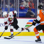 
              Ottawa Senators' Claude Giroux, left, shoots the puck against Philadelphia Flyers' Rasmus Ristolainen during the third period of an NHL hockey game, Saturday, Nov. 12, 2022, in Philadelphia. (AP Photo/Matt Slocum)
            
