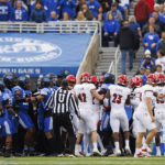 
              Kentucky and Louisville players are separated from a scrum during the first half of an NCAA college football game in Lexington, Ky., Saturday, Nov. 26, 2022. (AP Photo/Michael Clubb)
            