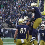 
              Notre Dame running back Audric Estime (7) celebrates with Joe Alt after Estime ran in for a touchdown during the first half of an NCAA college football game, Saturday, Nov. 19, 2022, in South Bend, Ind. (AP Photo/Darron Cummings)
            