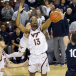 
              Virginia Tech's Darius Maddox (13) reaches for a rebound against Penn State's Andrew Funk (10) in the first half of an NCAA college basketball game at the Charleston Classic in Charleston, S.C., Friday, Nov. 18, 2022. (AP Photo/Mic Smith)
            