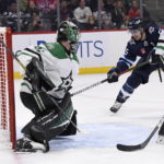 
              Winnipeg Jets' Mark Scheifele (55) scores on Dallas Stars goaltender Scott Wedgewood (41) during the second period of an NHL hockey game, Tuesday, Nov. 8, 2022 in Winnipeg, Manitoba. (Fred Greenslade/The Canadian Press via AP)
            