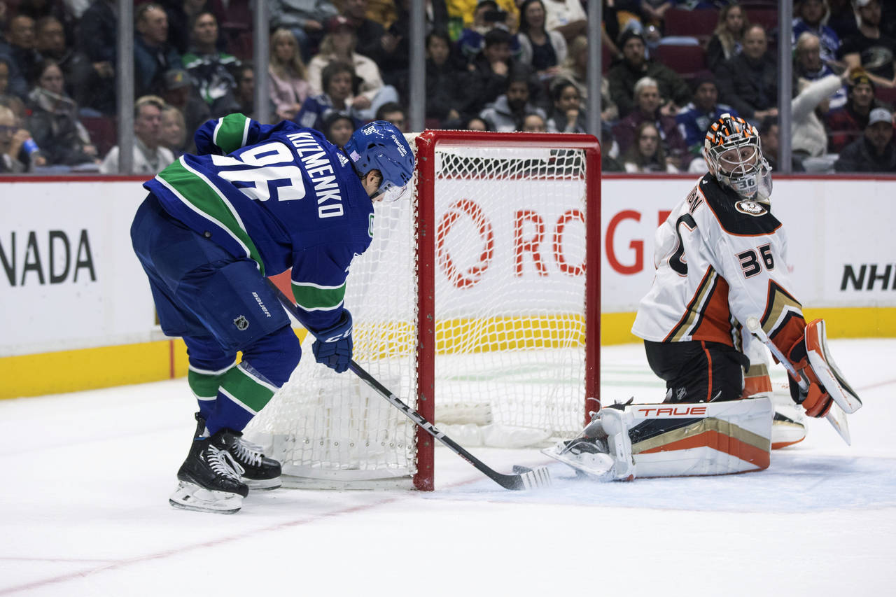 Vancouver Canucks' Andrei Kuzmenko (96) scores a goal against Anaheim Ducks goalie John Gibson (36)...