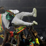 
              Senegal's players celebrate with Senegal's head coach Aliou Cisse after winning the African Cup of Nations 2022 final soccer match between Senegal and Egypt at the Ahmadou Ahidjo stadium in Yaounde, Cameroon, on Feb. 6, 2022. (AP Photo/Sunday Alamba, File)
            