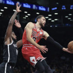 
              Chicago Bulls guard Zach LaVine (8) passes the ball as Brooklyn Nets forward Royce O'Neale (00) defends during the first half of an NBA basketball game Tuesday, Nov. 1, 2022, in New York. (AP Photo/Jessie Alcheh)
            