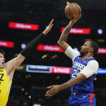 
              Los Angeles Clippers forward Norman Powell, right, shoots as Utah Jazz center Walker Kessler defends during the second half of an NBA basketball game Monday, Nov. 21, 2022, in Los Angeles. (AP Photo/Mark J. Terrill)
            