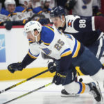 
              St. Louis Blues center Jordan Kyrou (25) tumbles while racing to recover the puck with Colorado Avalanche defenseman Andreas Englund (88) in the second period of an NHL hockey game Monday, Nov. 14, 2022, in Denver. (AP Photo/David Zalubowski)
            