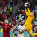 
              Tunisia's goalkeeper Aymen Dahmen saves a ball during the World Cup group D soccer match between Denmark and Tunisia, at the Education City Stadium in Al Rayyan , Qatar, Tuesday, Nov. 22, 2022. (AP Photo/Petr David Josek)
            