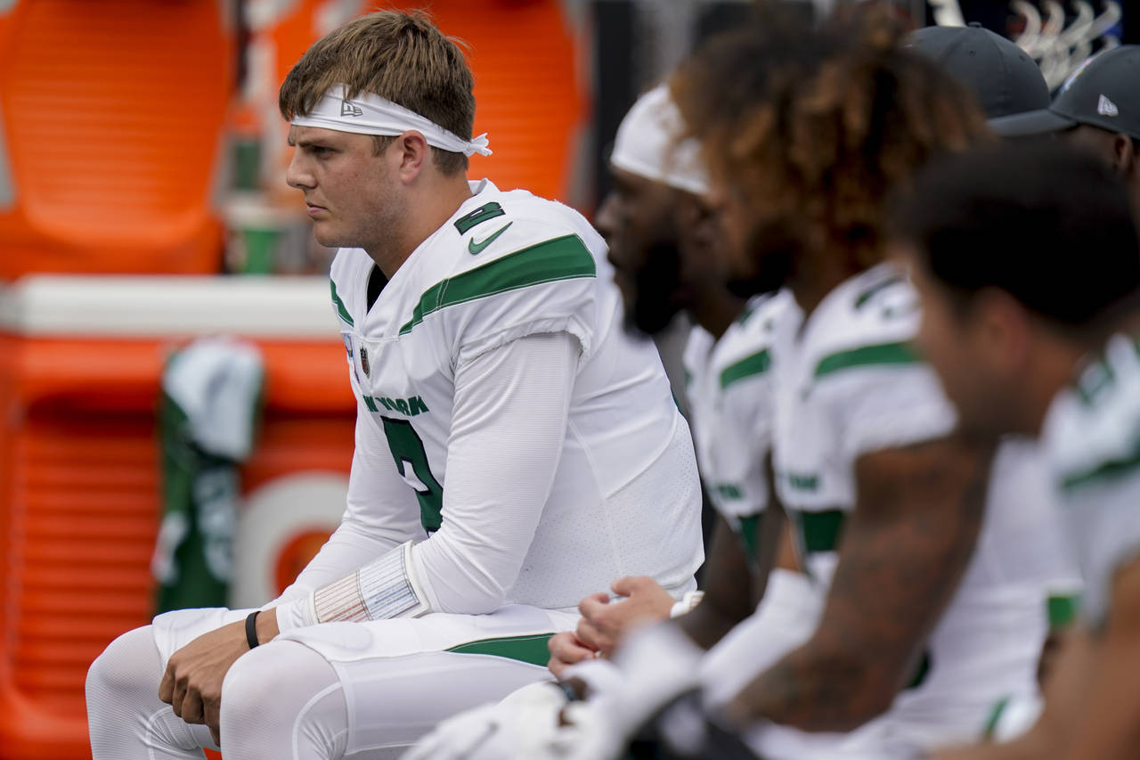 FILE - New York Jets quarterback Zach Wilson sits on the bench during the first half of an NFL foot...