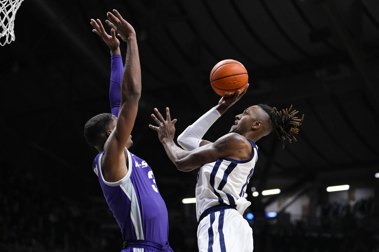 Butler center Manny Bates (15) shoots over Kansas State forward David N'Guessan (3) in the first ha...