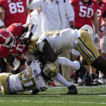 
              Georgia tight end Darnell Washington (0) is brought down down by Georgia Tech defenders LaMiles Brooks (20) and D'Quan Douse (99) during the first half of an NCAA college football game Saturday, Nov. 26, 2022 in Athens, Ga. (AP Photo/John Bazemore)
            