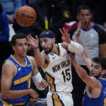 
              New Orleans Pelicans guard Jose Alvarado (15) passes between Golden State Warriors forward Patrick Baldwin Jr. (7) and guard Ty Jerome (10) in the second half of an NBA basketball game in New Orleans, Monday, Nov. 21, 2022. The Pelicans won 128-83. (AP Photo/Gerald Herbert)
            