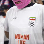 
              One of group of young women wearing colorful balaclavas who identified themselves as members of the Pussy Riot collective in the stands during the World Cup group B soccer match between Iran and the United States at the Al Thumama Stadium in Doha, Qatar, Tuesday, Nov. 29, 2022. (AP Photo/Ciaran Fahey)
            