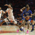 
              Eastern Illinois' Kinyon Hodges (10) strips the ball from Illinois' Terrence Shannon Jr. (0) during the first half of an NCAA college basketball game Monday, Nov. 7, 2022, in Champaign, Ill. (AP Photo/Michael Allio)
            