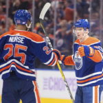 
              Edmonton Oilers' Darnell Nurse (25) and Connor McDavid (97) celebrate a goal against the Vegas Golden Knights during during overtime in an NHL hockey game Saturday, Nov. 19, 2022, in Edmonton, Alberta. (Jason Franson/The Canadian Press via AP)
            
