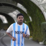 
              A fan in a Messi jersey runs at Al Gharafa Park in Doha, Qatar, Thursday, Nov. 24, 2022. Qatar unveiled a plan last October to cut its emissions by a quarter by 2030. Then, Russia invaded Ukraine and made the Persian Gulf nation's liquid natural gas only more sought after. Demand for fossil fuels has brought immense wealth to Qatar, but in the coming decades, it could also make one of the world's hottest places unlivable. (AP Photo/Abbie Parr)
            