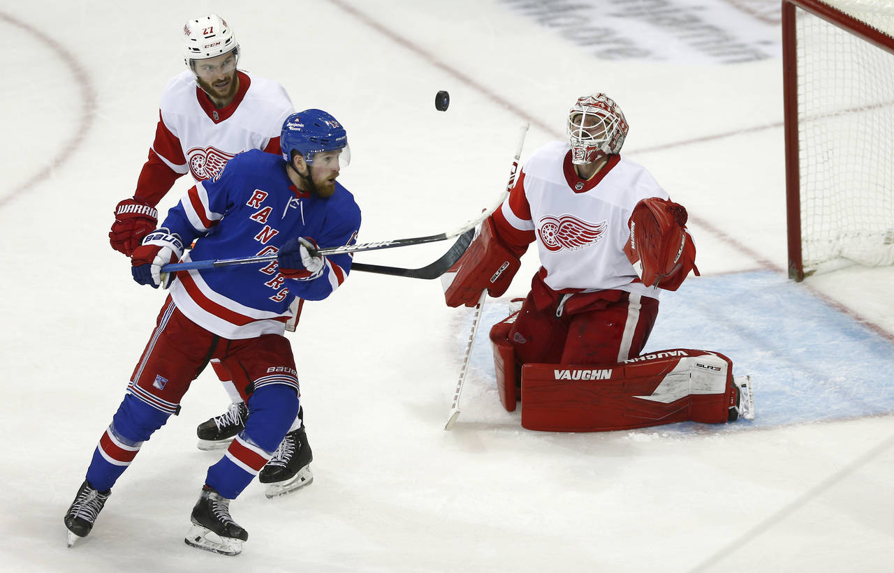 From left to right, Detroit Red Wings center Michael Rasmussen, New York Rangers left wing Alexis L...