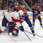 
              Florida Panthers' Aaron Ekblad (5) and Edmonton Oilers' Connor McDavid (97) battle for the puck during the third period of an NHL hockey game in Edmonton, Alberta, Monday, Nov. 28, 2022. (Jason Franson/The Canadian Press via AP)
            
