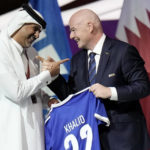 
              FILE - Prime Minister of the State of Qatar, Khalid Bin Khalifa Bin Abdulaziz Al Thani, left, receives a gift from FIFA President Gianni Infantino during the FIFA congress at the Doha Exhibition and Convention Center in Doha, Qatar, Thursday, March 31, 2022.A recent outpouring of local anger to scenes of foreign artists and models reveling in Qatar underscored the tensions tearing at the conservative Muslim emirate(AP Photo/Hassan Ammar, File)
            