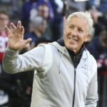 
              Seattle Seahawks head coach Pete Carroll waves to fans as he walks onto the field before an NFL football game against the Tampa Bay Buccaneers, Sunday, Nov. 13, 2022, in Munich, Germany. (AP Photo/Gary McCullough)
            