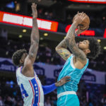 
              Charlotte Hornets center Nick Richards, right, shoots over Philadelphia 76ers forward Paul Reed, left, during the first half of an NBA basketball game Wednesday, Nov. 23, 2022, in Charlotte, N.C. (AP Photo/Rusty Jones)
            