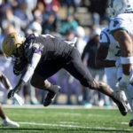 
              James Madison running back Percy Agyei-Obese (31) tries to stay on his feet as he navigates through Coastal Carolina defense during the first half of an NCAA college football game in Harrisonburg, Va., Saturday, Nov. 26, 2022. (Daniel Lin/Daily News-Record via AP)
            