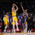 
              Los Angeles Lakers forward Matt Ryan (37) shoots and make a 3-point shot to send the game to overtime as New Orleans Pelicans guard Trey Murphy III defends during the second half of an NBA basketball game Wednesday, Nov. 2, 2022, in Los Angeles. (AP Photo/Mark J. Terrill)
            