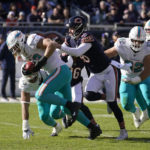 
              Miami Dolphins linebacker Andrew Van Ginkel runs in a touch down after linebacker Jaelan Phillips, left rear, blocked a kick by Chicago Bears punter Trenton Gill, third from left, during the first half of an NFL football game, Sunday, Nov. 6, 2022 in Chicago. (AP Photo/Charles Rex Arbogast)
            
