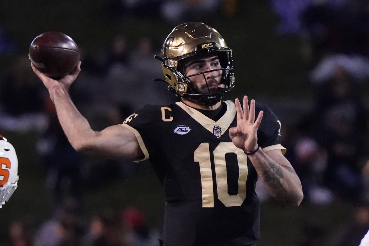 Wake Forest quarterback Sam Hartman (10) looks to pass against Syracuse during the first half of an...