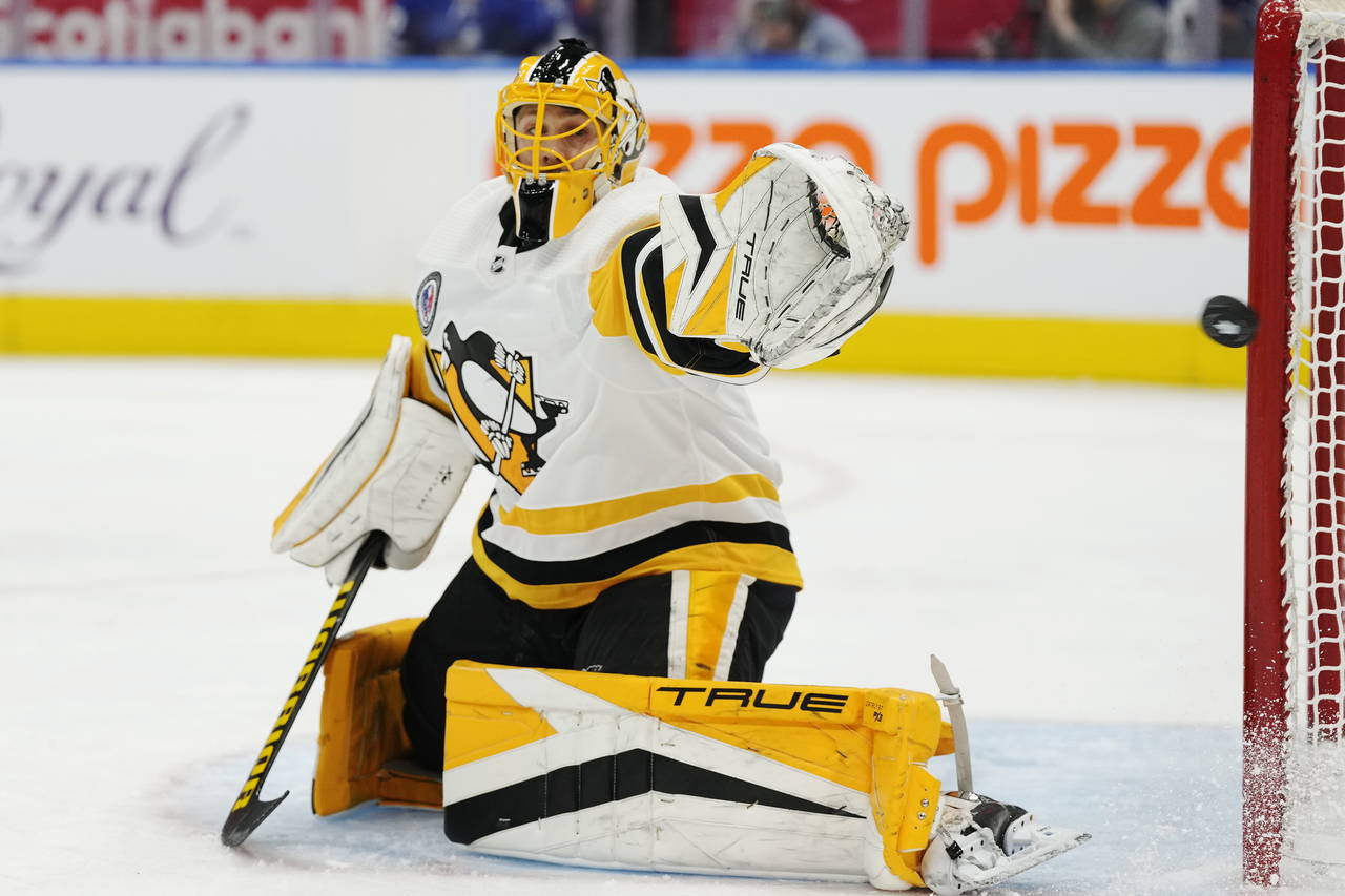 Pittsburgh Penguins goaltender Casey DeSmith watches as a Toronto Maple Leafs shot goes wide of the...