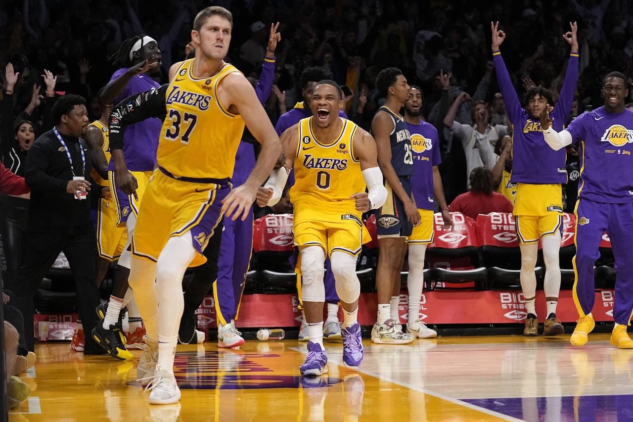 Los Angeles Lakers forward Matt Ryan, left, celebrates with guard Russell Westbrook, center, after ...