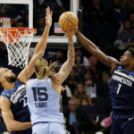 
              Memphis Grizzlies forward Brandon Clarke (15) has his shot block by Minnesota Timberwolves guard Anthony Edwards (1) with defensive help from center Rudy Gobert (27) in the third quarter of an NBA basketball game Wednesday, Nov. 30, 2022, in Minneapolis. (AP Photo/Andy Clayton-King)
            