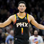 
              Phoenix Suns guard Devin Booker (1) reacts to a traveling call during the first half of an NBA basketball game against the Portland Trail Blazers, Friday, Nov. 4, 2022, in Phoenix. (AP Photo/Matt York)
            