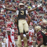 
              Florida State running back Trey Benson (3) is lifted, in celebration of his touchdown, by offensive lineman Jazston Turnetine during the third quarter of an NCAA college football game against Louisiana on Saturday, Nov. 19, 2022, in Tallahassee, Fla. (AP Photo/Gary McCullough)
            