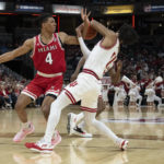 
              Indiana guard CJ Gunn and Miami (Ohio) guard Bryson Tatum (4) fight for a ball during the first half of an NCAA college basketball game, Sunday, Nov. 20, 2022, in Indianapolis. (AP Photo/Marc Lebryk)
            