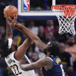 
              Indiana Pacers' Isaiah Jackson (22) is fouled by Denver Nuggets' DeAndre Jordan (6) as he goes up for a shot during the first half of an NBA basketball game, Wednesday, Nov. 9, 2022, in Indianapolis. (AP Photo/Darron Cummings)
            