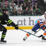 
              Dallas Stars defenseman Nils Lundkvist (5) and New York Islanders center Jean-Gabriel Pageau (44) compete for control of the puck in the second period of an NHL hockey game Saturday, Nov. 19, 2022, in Dallas. (AP Photo/Tony Gutierrez)
            