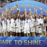 
              FILE - The United States' team celebrates with the trophy after winning the Women's World Cup final soccer match against The Netherlands at the Stade de Lyon in Decines, outside Lyon, France, July 7, 2019. (AP Photo/Alessandra Tarantino, File)
            