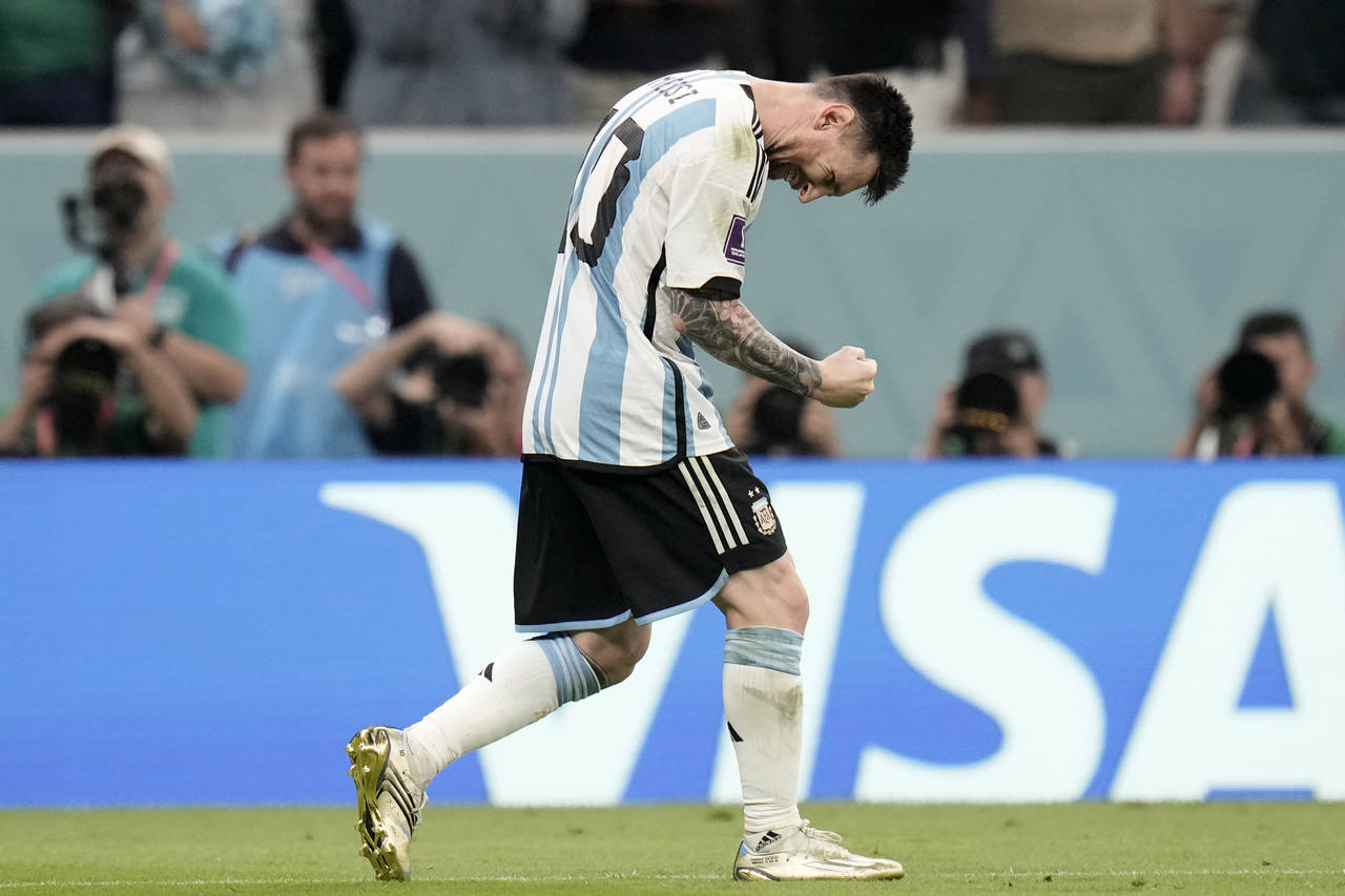 Argentina's Lionel Messi celebrates after scoring the opening goal during the World Cup group C soc...