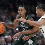 
              Eastern Michigan forward Emoni Bates (21) is defended by Michigan guard Jett Howard during the first half of an NCAA college basketball game, Friday, Nov. 11, 2022, in Detroit. (AP Photo/Carlos Osorio)
            