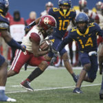 
              Oklahoma running back Eric Gray (0) is defended by West Virginia safety Malachi Ruffin (14) during the second half of an NCAA college football game in Morgantown, W.Va., Saturday, Nov. 12, 2022. (AP Photo/Kathleen Batten)
            