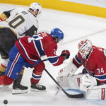 
              Vegas Golden Knights' Nicolas Roy (10) moves in on Montreal Canadiens goaltender Jake Allen as Canadiens' Kaiden Guhle (21) defends during the first period of an NHL hockey game Saturday, Nov. 5, 2022, in Montreal. (Graham Hughes/The Canadian Press via AP)
            