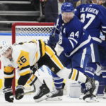 
              Toronto Maple Leafs' Morgan Rielly (44) checks Pittsburgh Penguins' Jason Zucker (16) during the second period of an NHL hockey game Friday, Nov. 11, 2022, in Toronto. (Frank Gunn/The Canadian Press via AP)
            